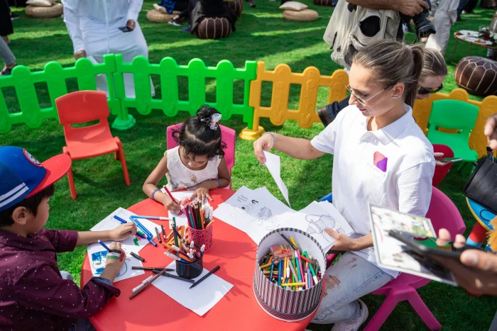 teacher taking care of children at a school event in Dubai